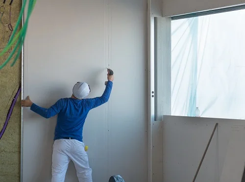 Photo showing our professional London Drylining Contractor working on a project.