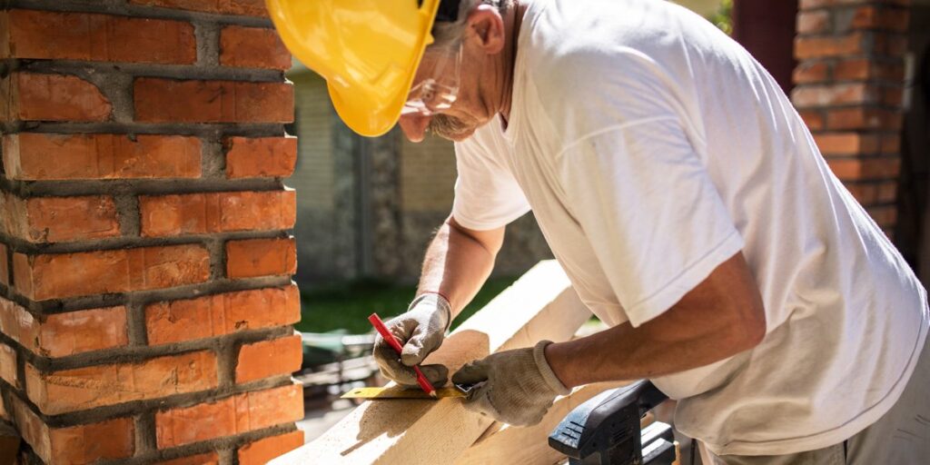 This is an image that shows a North London Builder working, which represents the article. Professional builders North London working on a brickwork project.